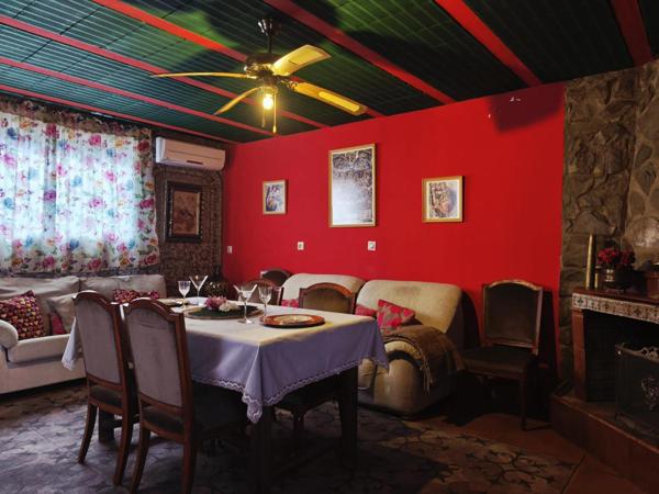 Salón con chimenea de piedra y pared roja